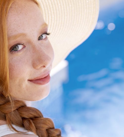 close-up-smiley-woman-by-pool