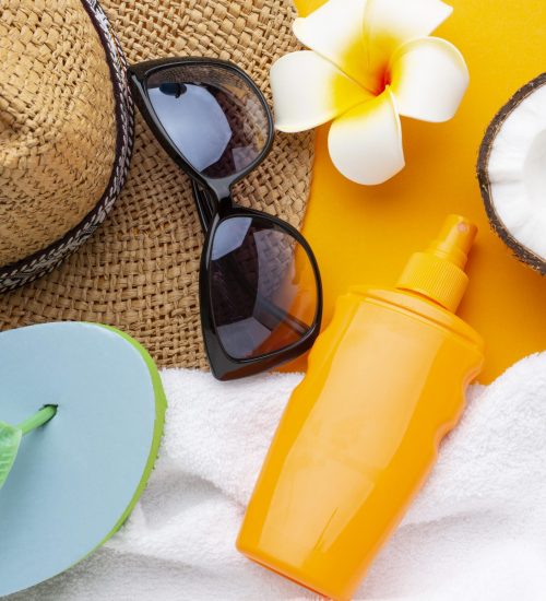 travel-items-yellow-background-top-view